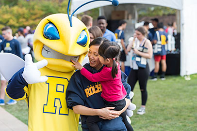 Father and daughter with mascot. Links to Under age 60. 
