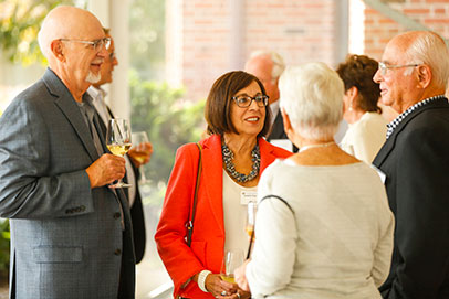 Alumni at an event. Links to Gifts of cash, checks, and credit cards. 