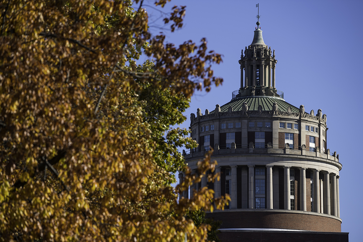 Kate Hidalgo in cap and gown at podium